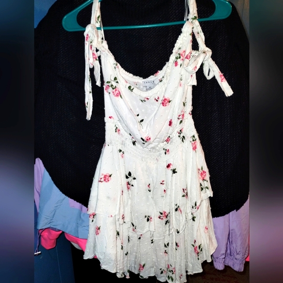 White Romper Dress with ruffle skirt, self tie straps, and floral embroidery. - Picture 5 of 6